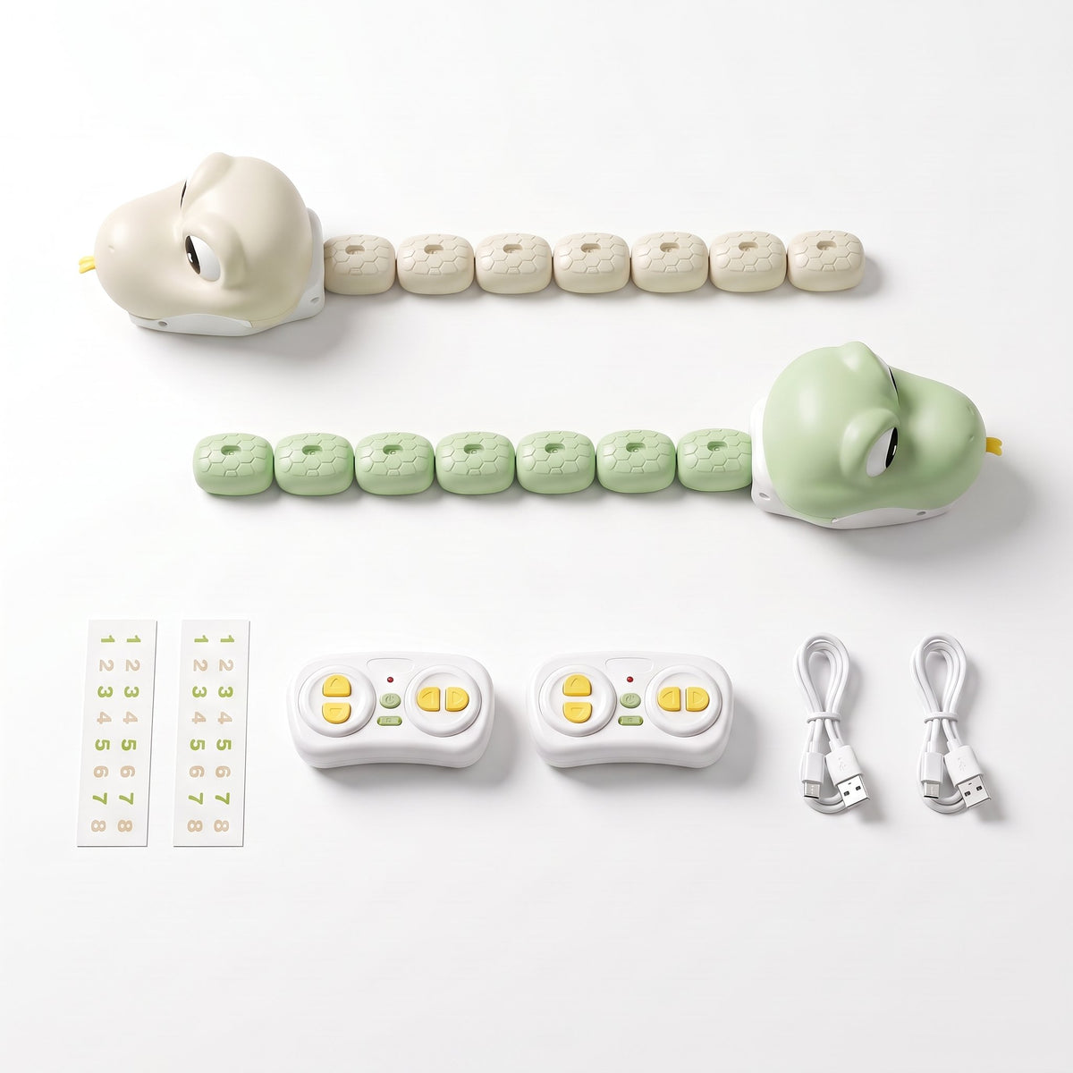 GreedySnake set with green and beige remote control snakes, two remotes and USB cables